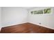 Empty bedroom boasting hardwood floors, a window view of nature, and white walls at 3363 Briarcliff Ne Rd, Atlanta, GA 30345
