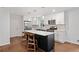 Modern kitchen features white cabinets, stainless steel appliances, and a black island with seating at 3363 Briarcliff Ne Rd, Atlanta, GA 30345