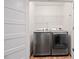 A laundry room with modern washer and dryer units and wire shelving at 3363 Briarcliff Ne Rd, Atlanta, GA 30345