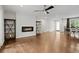 Open-concept living area with fireplace, ceiling fan, and hardwood floors at 3363 Briarcliff Ne Rd, Atlanta, GA 30345