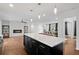 Open concept living with fireplace, kitchen island, and adjacent dining area at 3363 Briarcliff Ne Rd, Atlanta, GA 30345