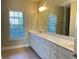 Bathroom featuring a long vanity with a large mirror and ample storage at 120 Chastain Nw Rd # 1803, Kennesaw, GA 30144