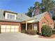 Charming brick home featuring an attached two-car garage and lush landscaping at 120 Chastain Nw Rd # 1803, Kennesaw, GA 30144