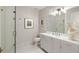 Well-lit bathroom with a glass door shower, toilet, white vanity, and decorative mirror at 210 Calypso Cir, Atlanta, GA 30305