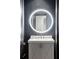 Modern powder room featuring dark gray brick accent wall, white vanity, and round mirror with LED lighting at 210 Calypso Cir, Atlanta, GA 30305