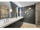 Bathroom with a double sink vanity, stone tile backsplash, and sleek glass shower door at 210 Calypso Cir, Atlanta, GA 30305
