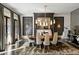 Elegantly decorated dining room featuring sophisticated modern lighting and large windows at 210 Calypso Cir, Atlanta, GA 30305