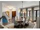 Bright dining room featuring modern lighting, a staircase, and dark hardwood flooring at 210 Calypso Cir, Atlanta, GA 30305
