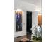 Entryway featuring modern art, elevator, and partial view of chandelier in background at 210 Calypso Cir, Atlanta, GA 30305