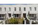 Charming townhome exterior featuring awning-covered windows and well-manicured landscaping at 210 Calypso Cir, Atlanta, GA 30305