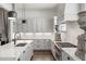 Stylish kitchen with white cabinets, marble countertops, stainless steel appliances, and a large, functional island at 210 Calypso Cir, Atlanta, GA 30305