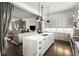 Bright, open kitchen featuring a marble island, stainless steel appliances, and seamless flow into the adjacent living area at 210 Calypso Cir, Atlanta, GA 30305