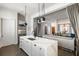 Bright kitchen with open layout flowing to the living room, featuring white cabinets and a marble island at 210 Calypso Cir, Atlanta, GA 30305