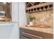 Granite bar top area featuring wine rack, glass storage, mosaic tile backsplash, and lovely decor at 2865 Lenox Road Ne # 602, Atlanta, GA 30324