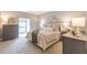 Bright bedroom featuring a luxurious queen bed, soft carpet, a window, and matching nightstands and dressers at 2865 Lenox Road Ne # 602, Atlanta, GA 30324