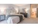 Cozy bedroom featuring a queen bed, soft carpet, and cool-toned decor, with a hallway leading to another room at 2865 Lenox Road Ne # 602, Atlanta, GA 30324