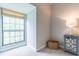 Bright corner space featuring a large window, neutral paint, carpet, and a charming side table at 2865 Lenox Road Ne # 602, Atlanta, GA 30324