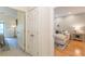 Hallway with view to a living area featuring wood floors and a comfortable sofa and a bedroom with plush carpets at 2865 Lenox Road Ne # 602, Atlanta, GA 30324