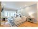 Bright living room with large sectional sofa, stone fireplace, and access to outdoor balcony at 2865 Lenox Road Ne # 602, Atlanta, GA 30324