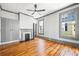 Bedroom with a fireplace, hardwood flooring, closet, and large windows at 34 N Broad N St, Porterdale, GA 30014