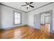 This bedroom features hardwood floors, ceiling fan and great natural light at 34 N Broad N St, Porterdale, GA 30014