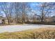 Spacious gravel driveway and yard, offering ample parking and outdoor space in a neighborhood setting at 34 N Broad N St, Porterdale, GA 30014