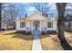 Inviting single-story home with a manicured lawn, a covered front porch, and classic architectural details at 34 N Broad N St, Porterdale, GA 30014