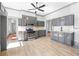 Spacious kitchen with gray cabinets, stainless appliances, tile backsplash, and eat-in area at 34 N Broad N St, Porterdale, GA 30014