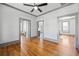 Bright living room boasts hardwood floors, neutral paint, modern ceiling fan, and charming architectural details at 34 N Broad N St, Porterdale, GA 30014