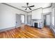 Open concept living room area with hardwood floors, fireplace, and grey accent at 34 N Broad N St, Porterdale, GA 30014