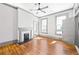 Sunlit living room features hardwood floors, neutral paint, fireplace, and lots of natural light at 34 N Broad N St, Porterdale, GA 30014