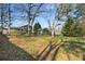 Expansive backyard featuring mature trees, a deck, and a shed, ideal for outdoor activities and storage at 4223 Mountain Glen Trce, Snellville, GA 30039