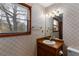 Bathroom with a vanity, sink, mirror, and a window bringing in natural light at 4223 Mountain Glen Trce, Snellville, GA 30039