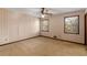 Cozy bedroom features a ceiling fan, carpet flooring, and two windows for natural light at 4223 Mountain Glen Trce, Snellville, GA 30039