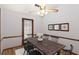 Dining room showcasing a wooden table set for six, hardwood floors, and natural light at 4223 Mountain Glen Trce, Snellville, GA 30039