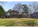 Traditional home featuring a brown exterior, a detached garage, and a spacious front yard at 4223 Mountain Glen Trce, Snellville, GA 30039