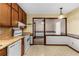 Charming kitchen featuring wood cabinets, white appliances, and a view to the dining area at 4223 Mountain Glen Trce, Snellville, GA 30039