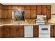 Bright kitchen featuring wood cabinets, white appliances, and laminate countertops at 4223 Mountain Glen Trce, Snellville, GA 30039
