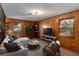 A cozy living room with wood paneling, and large windows for lots of natural light at 4223 Mountain Glen Trce, Snellville, GA 30039