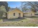 Rear view of a single-story home with a wooden deck and a detached garage at 1276 Clay Sw Rd, Mableton, GA 30126