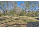 Large backyard with mature trees and space for outdoor activities at 1276 Clay Sw Rd, Mableton, GA 30126