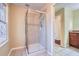 Bathroom with a glass shower, tiled floor, and a small window to provide natural light at 1276 Clay Sw Rd, Mableton, GA 30126