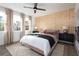 Beautiful bedroom showcasing a wood accent wall, a ceiling fan, and large sunny windows at 1578 Driggs Nw Dr # 171, Atlanta, GA 30318