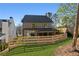 View of the home's backyard featuring a covered patio, privacy fence and professionally maintained lawn at 262 Green Hill Ne Rd, Sandy Springs, GA 30342