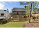 Backyard view with covered patio, privacy fence, and lush lawn creating an inviting outdoor space at 262 Green Hill Ne Rd, Sandy Springs, GA 30342