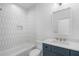 Modern bathroom with white tile, light blue vanity, and elegant fixtures at 262 Green Hill Ne Rd, Sandy Springs, GA 30342