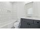 Chic bathroom with white tile, gray vanity, and elegant fixtures at 262 Green Hill Ne Rd, Sandy Springs, GA 30342