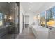 Bright bathroom featuring a soaking tub, glass-enclosed shower, double vanity, and stylish fixtures at 262 Green Hill Ne Rd, Sandy Springs, GA 30342