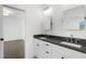 Bright bathroom boasts double sinks with black countertops and geometric floor leading to bedroom at 262 Green Hill Ne Rd, Sandy Springs, GA 30342