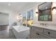 Modern bathroom featuring dual vanities, soaking tub under a large window, and glass-enclosed shower at 262 Green Hill Ne Rd, Sandy Springs, GA 30342